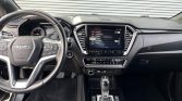 Isuzu car interior showing a multi‑function steering wheel, a central touchscreen display, and climate controls in the dashboard.