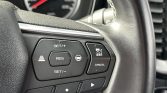 Close-up of a car steering wheel cruise control cluster: RES, SET+/-, and MODE/CANCEL buttons.