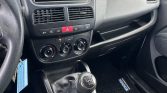 Compact car interior showing the center dashboard with a Pioneer stereo, air vents, climate controls, and a black manual gear stick in the foreground