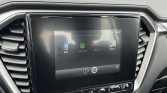 Car infotainment touchscreen showing Phone, Apple CarPlay, MirrorLink and Miracast options in a car dashboard