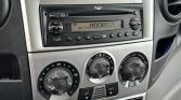 Dashboard of a car with a 'DAILY' branding plate above a radio and climate controls.