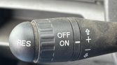 Car cruise control stalk with RES button and ON/OFF switch; plus/minus arrows for speed adjustment.
