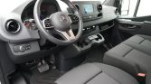 Interior of a modern van: steering wheel, instrument cluster, and center touchscreen