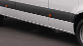 Side view of a white van with a black lower side panel and orange side marker lights along the length of the vehicle