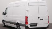 White Mercedes-Benz Sprinter cargo van photographed from the rear-right, with back doors closed and rider-style taillights visible.