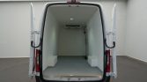 Rear of a white cargo van with double doors open, showing an empty insulated cargo area ready for loading.