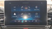 Infotainment touchscreen displaying eight app tiles: Radio, Media, Phone, Apple CarPlay, Android Auto, Climate, Camera, Telematics.