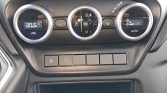 Vehicle climate control panel with three circular dials: left shows 20.5°C, middle for fan/temp settings, right Auto with airflow indicator. Beneath are blank control buttons.