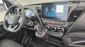 Interior of a modern van: steering wheel, digital dashboard, and a large central touchscreen showing navigation and media