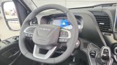 Multifunction steering wheel in an Iveco vehicle cabin with a digital instrument cluster and center console nearby