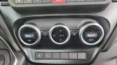 Three circular climate control dials: left shows 30.5°C temperature, center adjusts fan/modes, right is in AUTO with a fan bar indicator; row of vehicle controls above includes hazard lights button