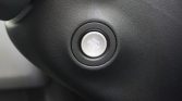 Push-button engine start/stop switch on a car dashboard