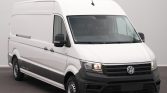 White Volkswagen cargo van, front three-quarter view, high roof, black bumper and grille