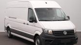 White Volkswagen cargo van, front-right view parked indoors, showing side panel and black bumper