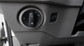 Car dashboard: round headlight control dial with positions for off, parking lights, and low beams; fog light symbol on the dial's left side.