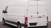 Rear and left-side view of a white Volkswagen Crafter cargo van with closed rear doors, in a neutral studio setting.