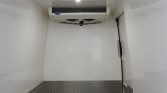 White refrigeration trailer interior with a ceiling-mounted AC unit and diamond-plate base trim at the bottom edge.
