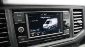 In-car infotainment screen showing Wagenstatus with a white van graphic and Start-stop option.