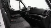 Interior view of a modern van cockpit with two front seats and a central touchscreen display.