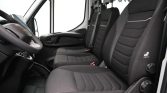 Dark fabric van interior showing driver’s area with three front seats and steering wheel on the left