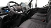 Interior of a modern van cockpit with steering wheel, digital dashboard, and front seats