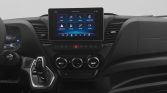 Center-dash infotainment touchscreen with climate controls and gear shifter visible in a modern car interior