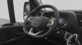 Interior view of a modern Iveco truck cabin showing a steering wheel, digital instrument cluster, and gear selector.