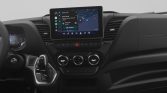 Interior of a car dashboard with a central touchscreen showing a navigation map and app icons.
