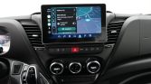 In-car infotainment touchscreen showing a navigation map and app icons on the dashboard center console