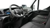 Left-hand drive van interior with steering wheel, digital dashboard, and touchscreen infotainment.