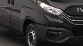 Front-left view of a dark gray Iveco van, showing the headlight, grille, and front wheel in frame.