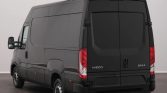 Rear view of a dark gray Iveco Daily commercial van with closed rear doors in a studio setting.