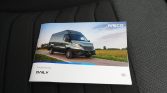 Iveco Daily van brochure on a car seat with a blue sky photo on the cover