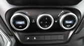 Car climate control panel with left digital temperature 17.0°C and A/C on, center control wheel, and right AUTO fan display.