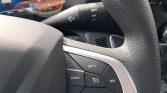 Close-up of a car steering wheel's cruise control buttons: SET+, SET-, CANCEL, RES, and the cruise icon in the center.