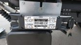 Plate-mounted lift control label showing Lift/Lower and Open/Close directions on a Dhollandia tail lift assembly.