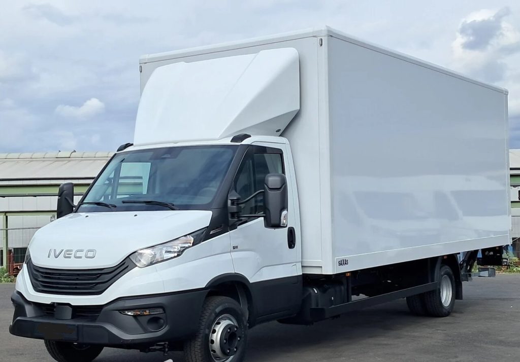 White Iveco delivery truck with a large rectangular cargo box parked on pavement, front and side view visible.]