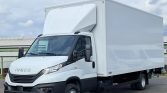 White Iveco delivery truck with a large rectangular cargo box parked on pavement, front and side view visible.]