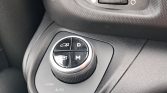 Circular drive-mode dial in car with four quadrants labeled D, M, and two icons; surrounding panel reads LOAD, AUTO, SOFT