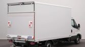 White box truck with cargo doors closed, viewed from the rear in a studio setting.