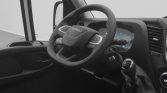 Interior of an Iveco van cockpit featuring a steering wheel, gear lever, and digital dashboard