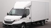 White Iveco delivery truck with a large enclosed cargo box, parked indoors.
