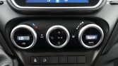 Car climate control panel with three circular dials; left shows LO temperature, middle for fan and mode, right shows AUTO with a small display and airflow icon