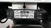 Close-up of a lifting device control plate with LIFT, LOWER, OPEN, CLOSE labels and orange directional arrows