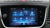 Car infotainment touchscreen home screen showing app icons: Radio, Media, Apple CarPlay, Android Auto, Phone, Vehicle, Settings, and Screen Off.