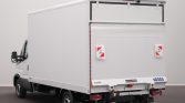 White box truck seen from the rear-left side with cargo box and branding on the back doors (Iveco/Saxas).
