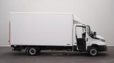 Side view of a white box truck with a large cargo area; the driver’s door is open, shown in a showroom setting