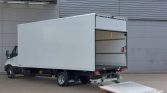 White box truck with the rear cargo area open and a loading ramp extended for unloading or loading goods.
