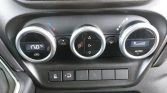 Car climate control panel with three round dials; left shows 17.0°C temperature, middle dial for fan and air flow, right displays AUTO with fan speed indicator; row of small function buttons beneath.