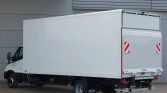 White box truck (cargo van) parked in an industrial courtyard, side and rear doors closed, with Saxas branding on the wheel arch and bumper area